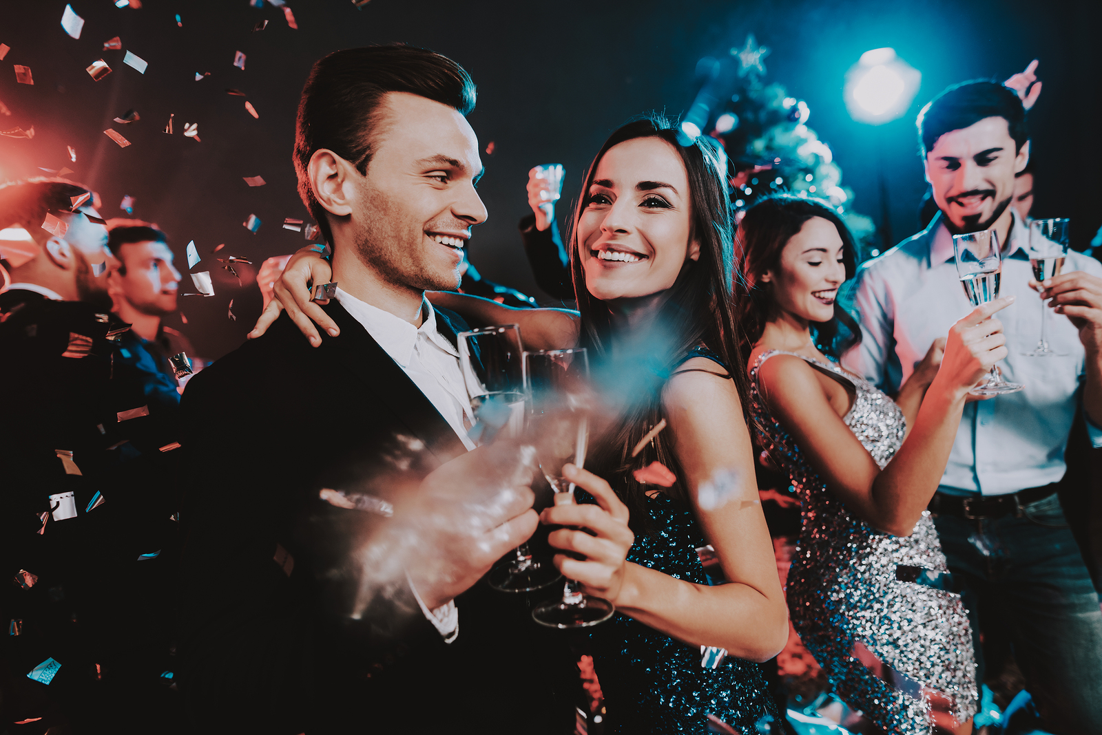Happy Young People Dancing on New Year Party. Happy New Year Concept. Glass of Champagne. Celebrating of New Year. Young Woman in Dress. Young Man in Suit. Happy People. Modern Dances.